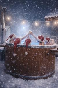 a group of people in a hot tub in the snow at Warmia Prestige in Woryty