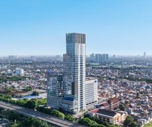 an aerial view of a tall building in a city at Novotel Jakarta Pulo Mas in Jakarta