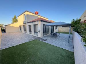 a house with a patio with a black umbrella at Ocean Whisper in Wannanup