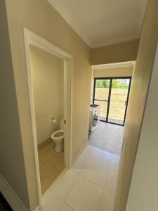 an empty bathroom with a toilet and a window at Ocean Whisper in Wannanup +18 photos