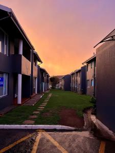 an empty parking lot between two apartment buildings at Palmar Hotel in Johannesburg