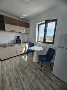 a kitchen with a table and chairs in a room at Luxury LCF in Brăila