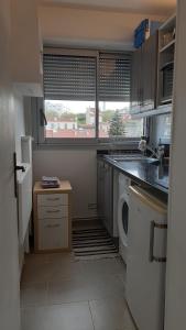 a kitchen with a washing machine and a window at LePré Apartment 93 in Le Pré-Saint-Gervais +16 photos