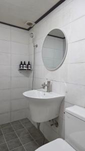 a white bathroom with a sink and a mirror at Stay jongno238 in Seoul +75 photos
