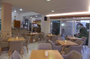 a restaurant with tables and chairs in a room at Barbie II in Ialysos