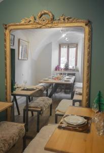 a dining room with a mirror and a table at Gite Le Rebanchon in Le Monêtier-les-Bains