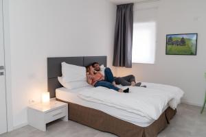 a man and woman laying on a bed at Le Vette in Rovereto