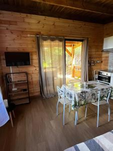 a dining room with a table and chairs in a cabin at Les chalets de la mare in Entre-Deux