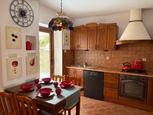 a kitchen with a table with red dishes on it at Plażowa Przytulny Dom Na Wyłączność in Białystok