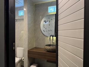 a bathroom with a sink and a toilet at Casa Sundara in Patjung