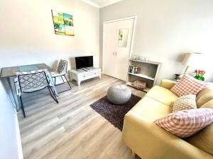 a living room with a couch and a table at Ocean Reef Retreat in Perth