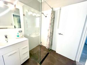 a bathroom with a shower and a sink at Ocean Reef Retreat in Perth +9 photos