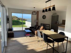 a living room with a table and a couch at Chez Tristan in Plouguerneau