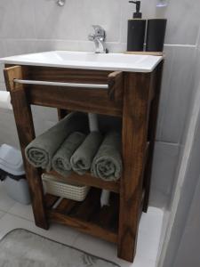 a bathroom with a sink and towels under it at Merlo mar 2 in Merlo