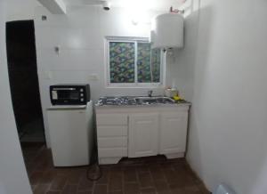 a small kitchen with a sink and a window at Merlo mar 2 in Merlo