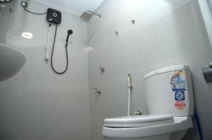 a bathroom with a toilet and a shower at French Villa in Dankotuwa +29 photos