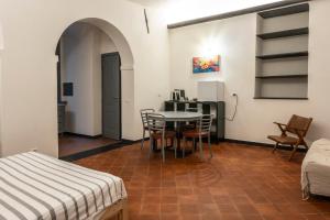 a bedroom with a table and chairs in a room at Affittacamere Bernardo Ricci in Albenga