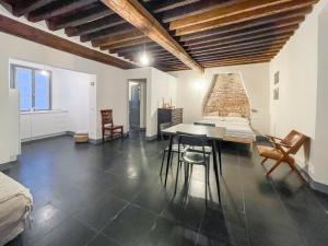 a room with a table and chairs and a brick wall at Affittacamere Bernardo Ricci in Albenga +53 photos