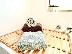 a towel sitting on top of a bed at Ocean Reef Retreat in Perth