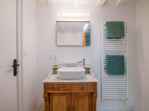 a bathroom with a sink and a mirror at La Garencière - La Petite Maison in Champfleur