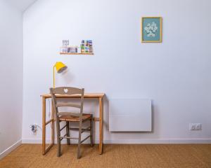 a desk with a chair and a lamp at La Garencière - La Petite Maison in Champfleur