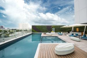 a swimming pool on top of a building at Grand Fiesta Americana Puebla Angelópolis in Puebla