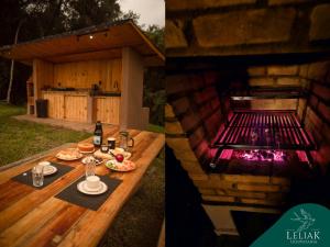 a picnic table with a grill in a backyard at Hospedaria Leliak - Retiro Boutique de Montanha in Aiuruoca