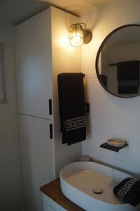 a bathroom with a sink and a mirror at Tiny House Auszeit in Nabegg +14 photos