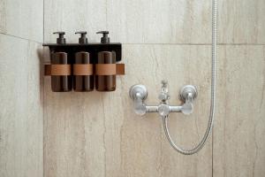 a shower system with a shower head on a wall at Kyma Paros Sea View Luxe Suite in Paros National Airport