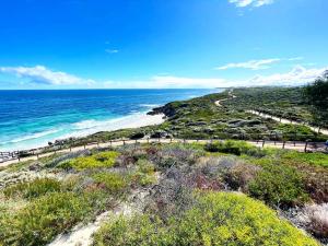 a view of the ocean from the top of a hill at Ocean Reef Retreat in Perth