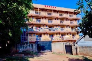 an apartment building with a sign on the side of it at Stylish Smart Studio Apartment in Kampala