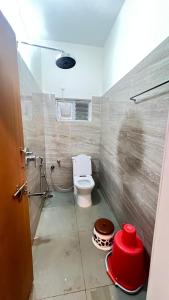 a small bathroom with a toilet and a shower at Bakthapriya HILL VIEW RESIDENCY in Srikalahasti +15 photos