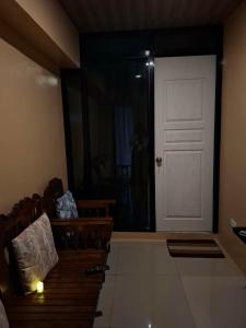 a living room with a white door and a couch at Queenbee's Place in Tagum