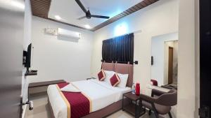 a hotel room with a bed and a chair at Bakthapriya HILL VIEW RESIDENCY in Srikalahasti