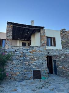 a stone building with a roof on top of it at Cycladic Serenity Sunset View Home in Otziás