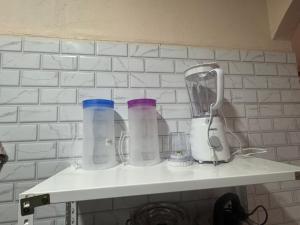 a shelf with four different colored cups on it at ff HILLTOP VIEW in Kampong Kundassan