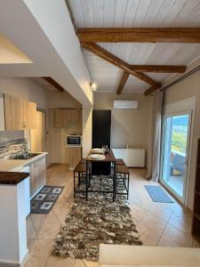 a kitchen with a table and a dining room at Κτήμα Παππά Ρετιρέ in Livadeia