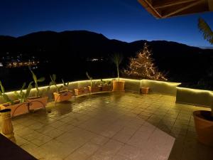 a patio with a christmas tree in the background at Κτήμα Παππά Ρετιρέ in Livadeia