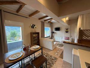 a kitchen and living room with a table and a living room at Κτήμα Παππά Ρετιρέ in Livadeia +2 photos