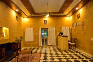 a living room with a checkered floor and a door at Desert Popular Resort & Camp in Jaisalmer