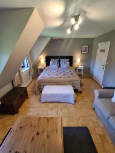 a large bedroom with a bed and a couch at Villa Sparadis in Spa