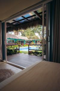 a bedroom with a sliding glass door to a pool at Nuiya Hoteles Centro in Sayulita