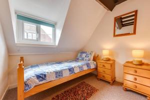 a bedroom with a bed and a window and a dresser at 3 Bed in Whitby oc-w009 in Whitby