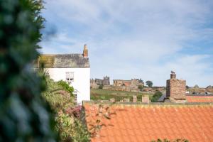 an old white building with a town in the background at 3 Bed in Whitby oc-w009 in Whitby