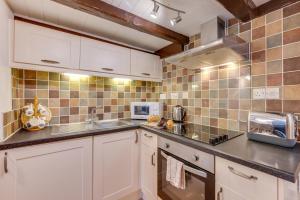 a kitchen with a sink and a microwave at 3 Bed in Whitby oc-w009 in Whitby