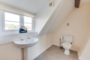 a white bathroom with a sink and a toilet at 3 Bed in Whitby oc-w009 in Whitby +6 photos