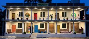 a building with many different doors on it at WoodPacker Hostel Auroville Pondicherry in Auroville