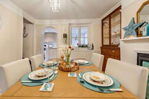 a dining room with a wooden table and chairs at 2 Bed in Appledore oc-s29561 in Appledore
