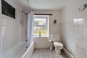 a bathroom with a toilet and a tub and a window at 2 Bed in Appledore oc-s29561 in Appledore +21 photos