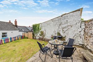 a patio with a table and chairs in a yard at 2 Bed in Appledore oc-s29561 in Appledore
